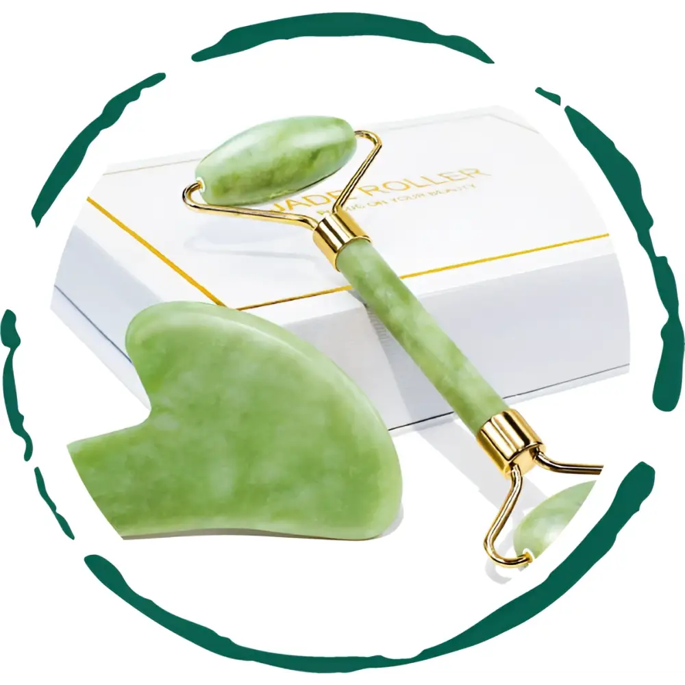 Green jade facial roller and matching gua sha massage tool with gold-toned accents in a jade rolling and sha gift set
