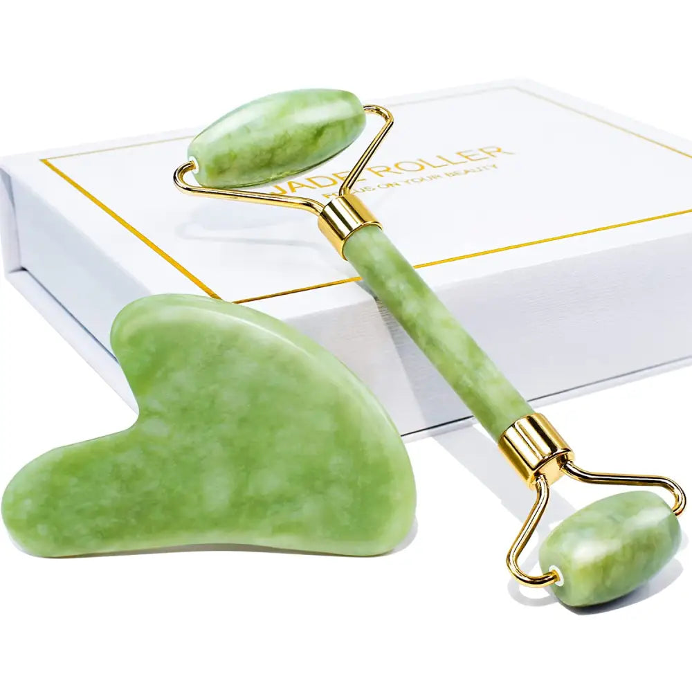 Green jade roller and matching gua sha gift set with gold toned metal handle for jade rolling and facial massage