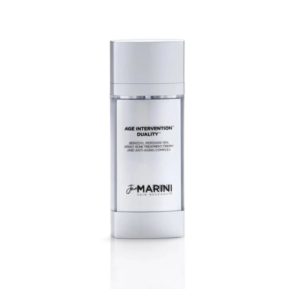 A sleek glass bottle with silver top of jan marini age intervention duality adult acne and anti-aging cream