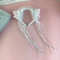 Pink and white japanese girl cute cat ear headband with lace trim, ribbon tassels, and small gold cute bells plush