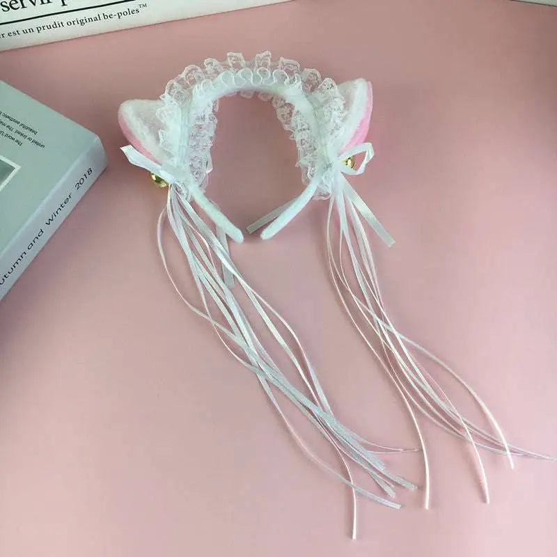 Pink and white japanese girl cute cat ear headband with lace trim, ribbon tassels, and small gold cute bells plush
