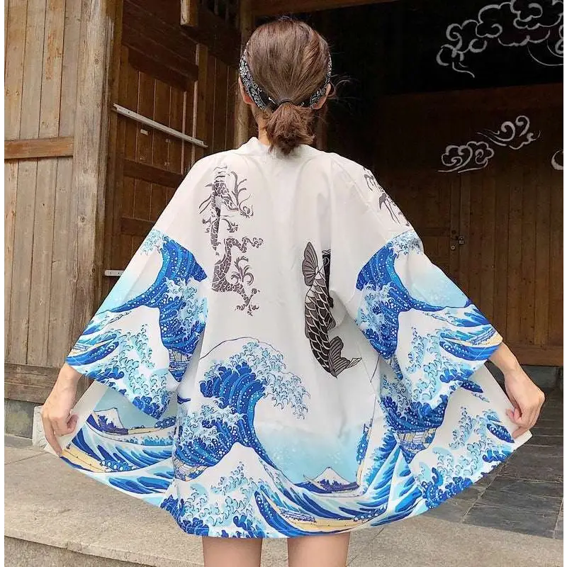 White kimono-style sun protection clothing with japanese wave print and vibrant fish prints inspired by hokusai