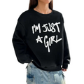 Black oversized sweatshirt with bold white girl print round crew neck and im just a girl text across the chest