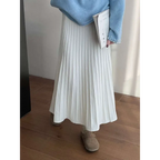 A flowing white korean elastic waist knitted pleated midi skirt made of soft lightweight fabric that drapes elegantly