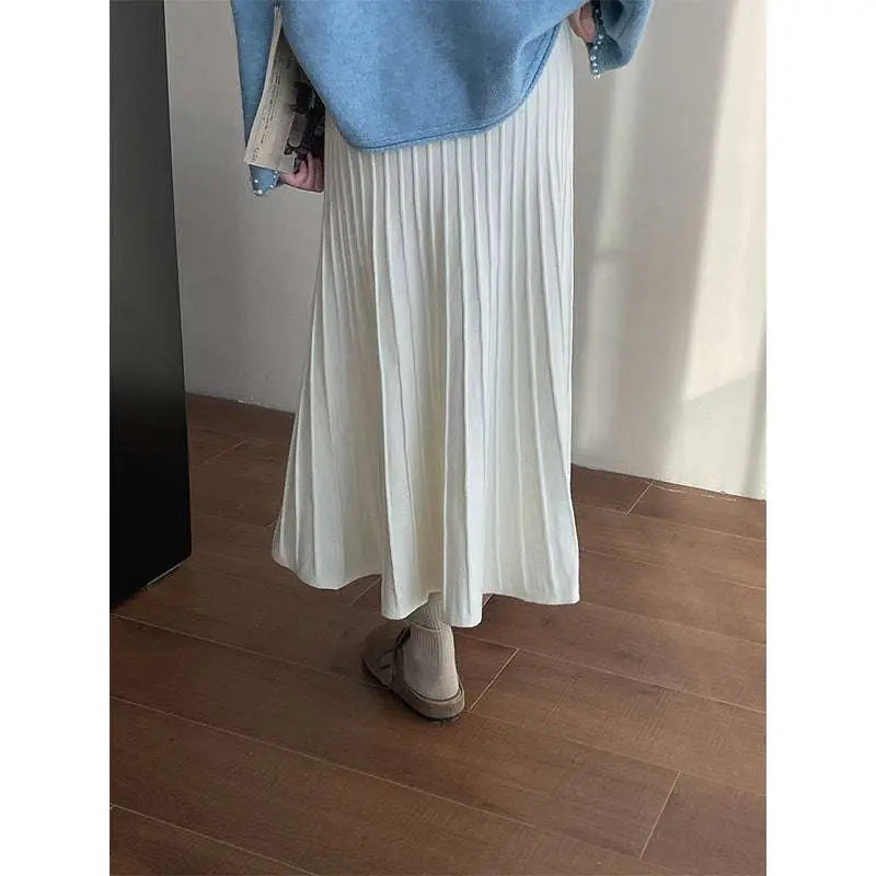 A flowing white korean elastic waist knitted pleated midi skirt made of soft lightweight fabric
