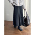 Dark gray korean elastic waist knitted pleated midi skirt with soft textured fabric and subtle vertical ridges