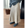 A soft beige korean elastic waist knitted pleated midi skirt with textured knit-like fabric