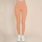 A pair of peach-colored korean fashion high waisted bow yoga pants made of smooth stretchy fabric