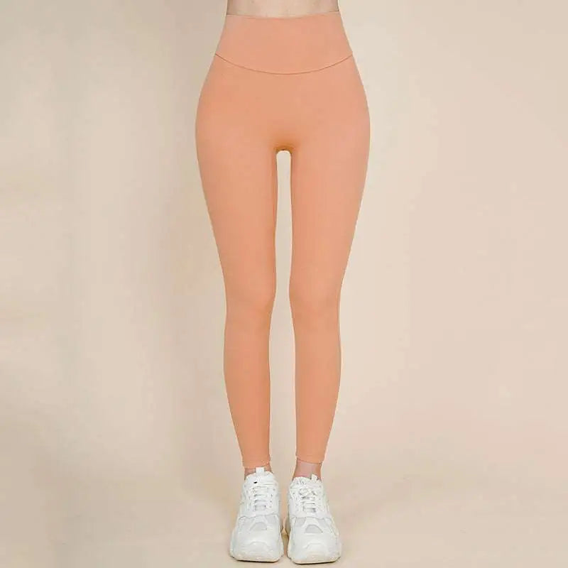 A pair of peach-colored korean fashion high waisted bow yoga pants made of smooth stretchy fabric
