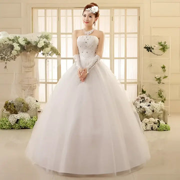 White strapless lace wedding dress with intricate beading and lace detailing featuring a strapless bodice paired design
