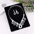 A korean wedding silver rhinestone necklace with teardrop crystal pendants and matching dress accessories jewelry set