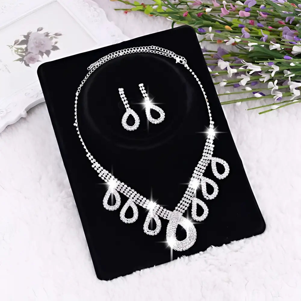 A korean wedding silver rhinestone necklace with teardrop crystal pendants and matching dress accessories jewelry set