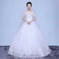 White off-the-shoulder wedding gown with intricate lace detailing and beaded floor length hemline in short sleeves