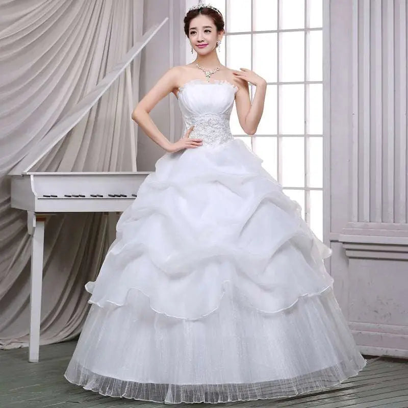 Strapless white bride wedding dress with lace bodice and beaded tulle layers in a lace and beaded tulle bride gown