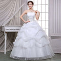 Strapless white bride wedding dress with lace bodice and beaded tulle layers in a lace and beaded tulle bride gown