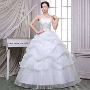 Strapless white bride wedding dress with lace bodice and beaded tulle layers in a lace and beaded tulle bride gown
