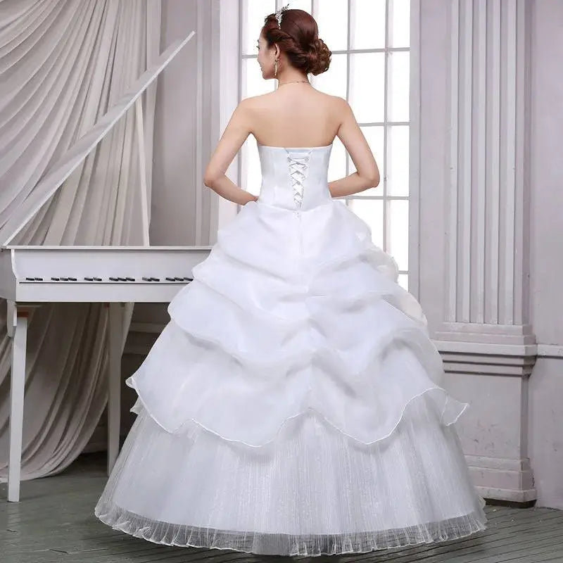 Strapless white bride wedding dress with lace bodice and beaded tulle layers in a lace and beaded tulle bride gown