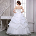 White strapless bride wedding dress with corseted back and layered beaded tulle skirt for tulle bride wedding