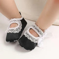 Black baby toddler shoes with white lace trim and a matching bow lace bow princess design