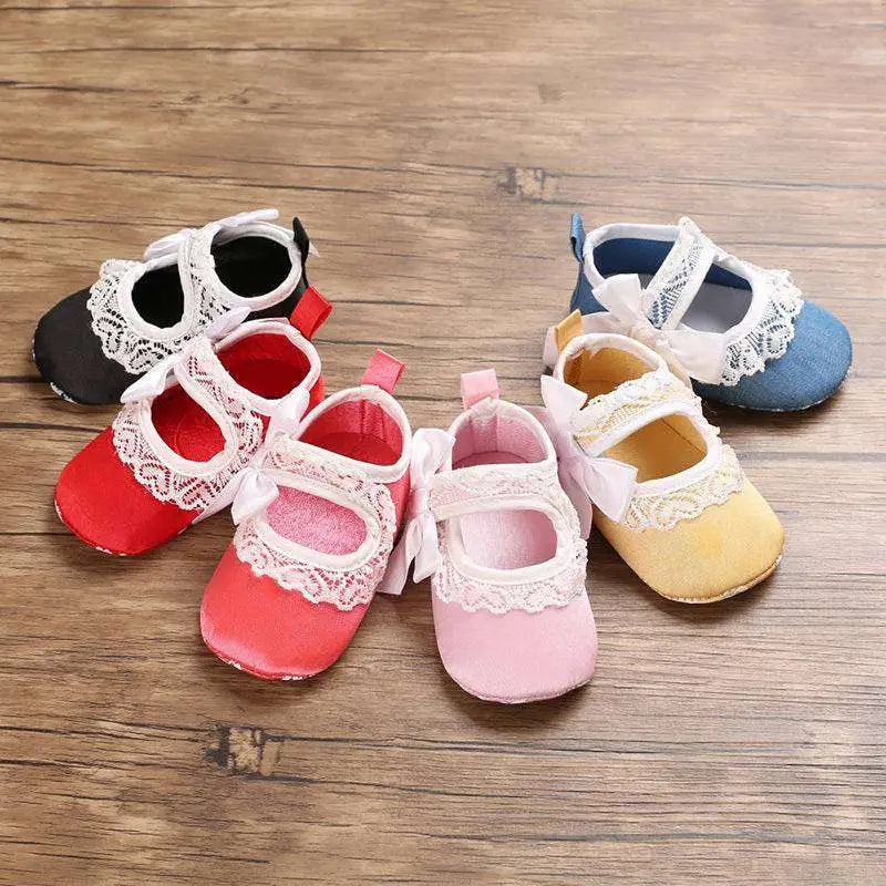 Pastel pink princess shoes baby with delicate white lace trim and matching lace bow for baby toddler shoes