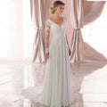 White lace long sleeve wedding dress with backless deep v-neckline and intricate lace detailing on bodice and sleeves