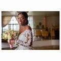 Elegant off-the-shoulder white lace long sleeve custom wedding gown with intricate floral detailing for bridal dresses