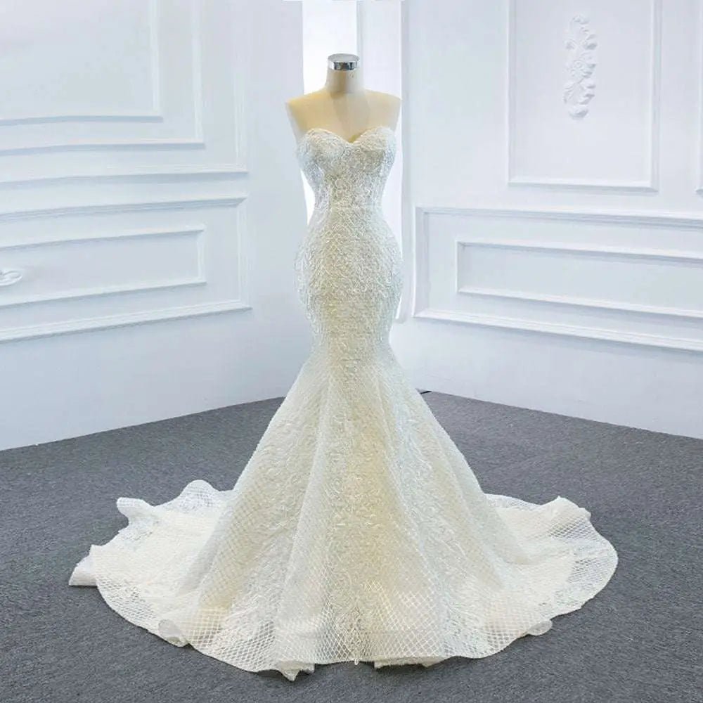 White lace mermaid wedding dress with sweetheart neckline intricate beading and two fishtail train design