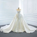 A white lace mermaid wedding dress with intricate detailing and two fishtail train flowing elegantly