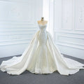A stunning white lace mermaid wedding dress with intricate detailing and a flowing two fishtail train