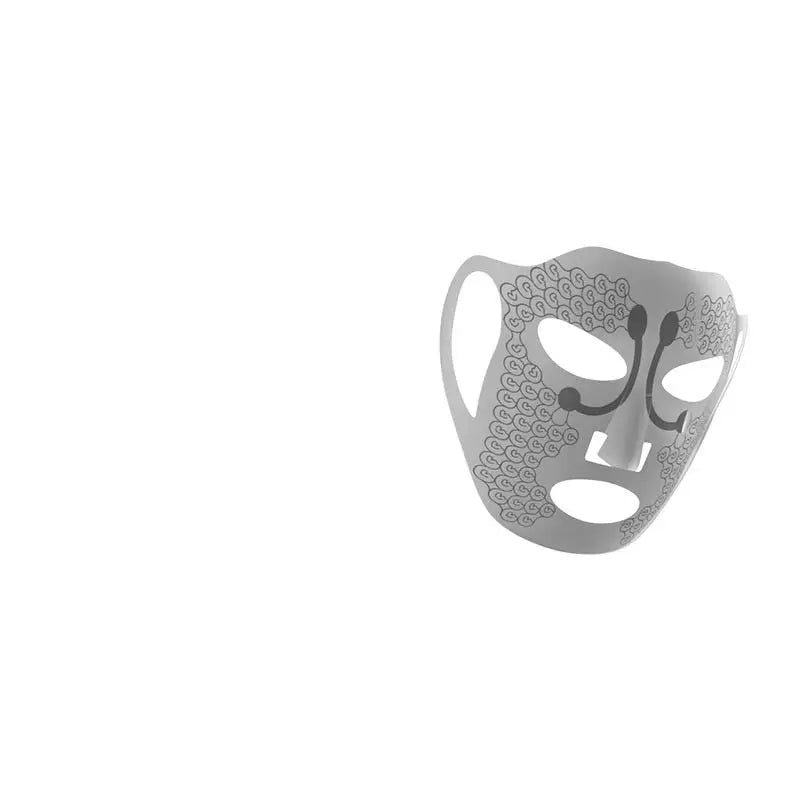 Silver metallic electric facial massage mask with intricate swirling lace circular patterns etched on its surface