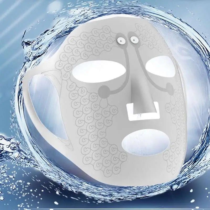 White electric facial massage mask with intricate swirling lace pattern and black sensor pad on forehead for facial massage