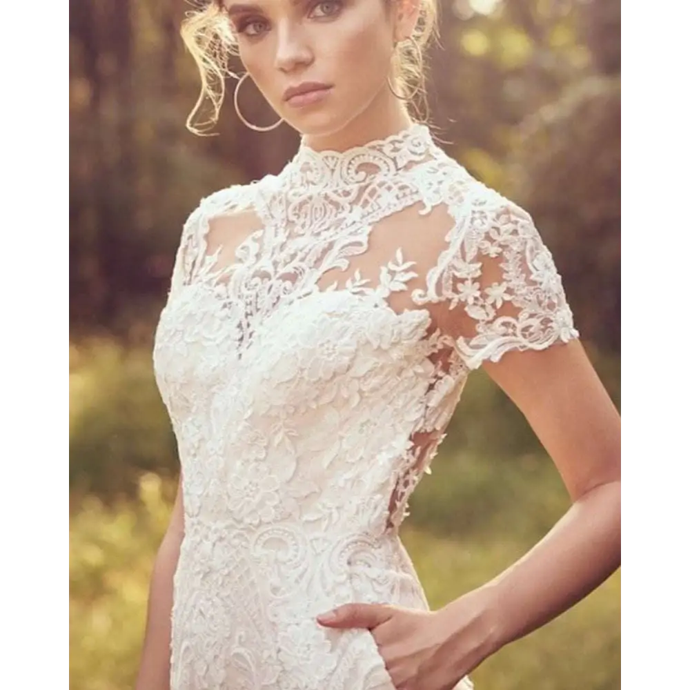 White lace bride pants suit with intricate floral embroidery and short sleeves for a suit wedding jumpsuit