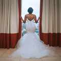 White sleeveless big tail african mermaid wedding dress with fitted bodice and intricate lace back detail shown from back