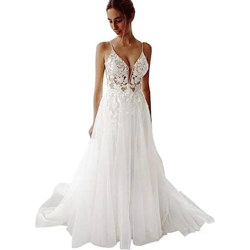 A white lace strap backless v neck wedding dress with intricate floral embroidery and a flowing tulle skirt