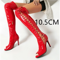 Vibrant red patent leather over the knee boots with lace up detailing and peep toe design for stylish wear
