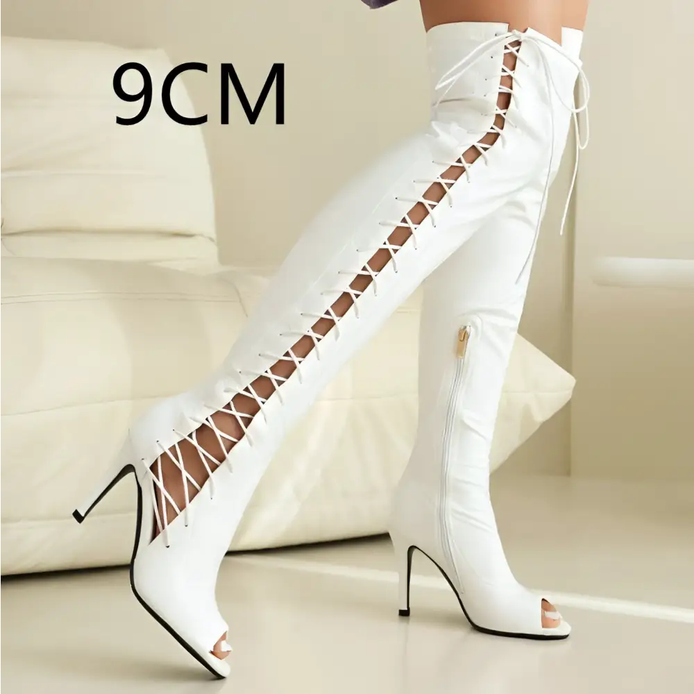 White patent leather lace up peep toe over the knee boots featuring high heels and stylish detailing