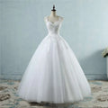 A white floor-length waist wedding dress featuring intricate lace v neck detailing on the bodice and skirt