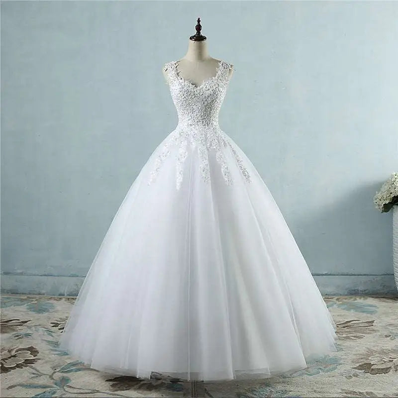 A white floor-length waist wedding dress featuring intricate lace v neck detailing on the bodice and skirt