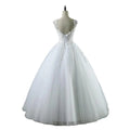 White lace v neck waist wedding dress featuring intricate lace detailing and a voluminous tulle skirt