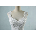 White lace v neck waist wedding dress featuring intricate floral embroidery and delicate shoulder straps