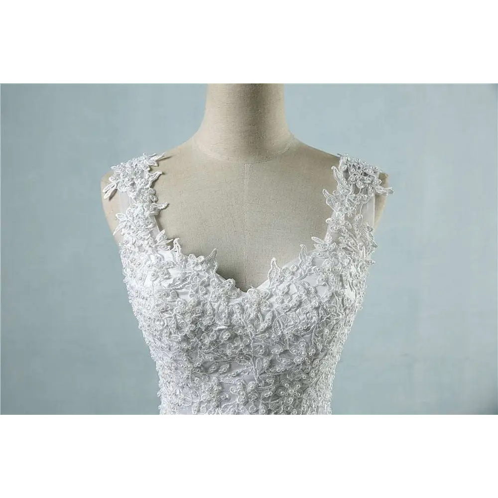 White lace v neck waist wedding dress featuring intricate floral embroidery and delicate shoulder straps