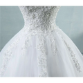 White waist wedding dress with lace v neck featuring intricate lace detailing and a flowing tulle skirt