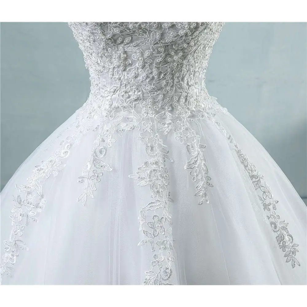 White waist wedding dress with lace v neck featuring intricate lace detailing and a flowing tulle skirt