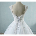 White lace v neck waist wedding dress featuring intricate floral embroidery and delicate back lacing detail