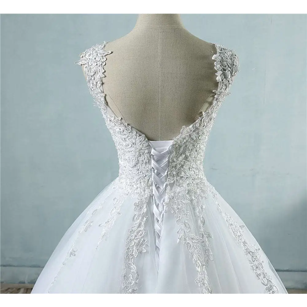 White lace v neck waist wedding dress featuring intricate floral embroidery and delicate back lacing detail