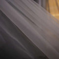 Delicate white tulle lace wedding dress fabric with subtle sheen and fine weave for trailing floral bridal veil