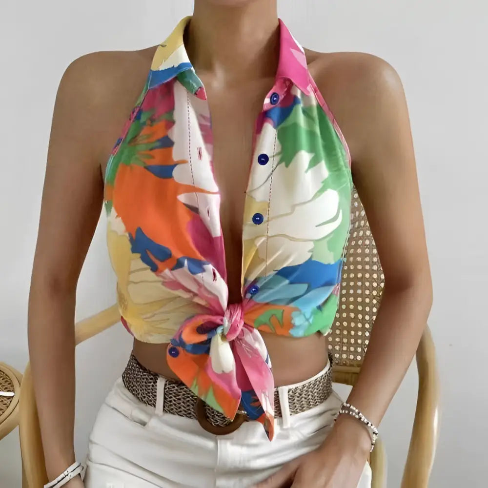 Ladies colorful floral print sleeveless halter top in bold pink green and orange hues on lightweight fabric