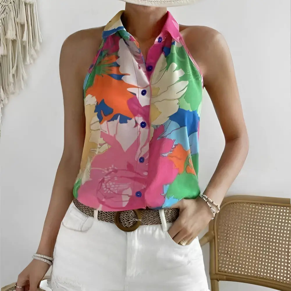 Ladies colorful floral print sleeveless halter top in bold pink green and orange hues on lightweight fabric