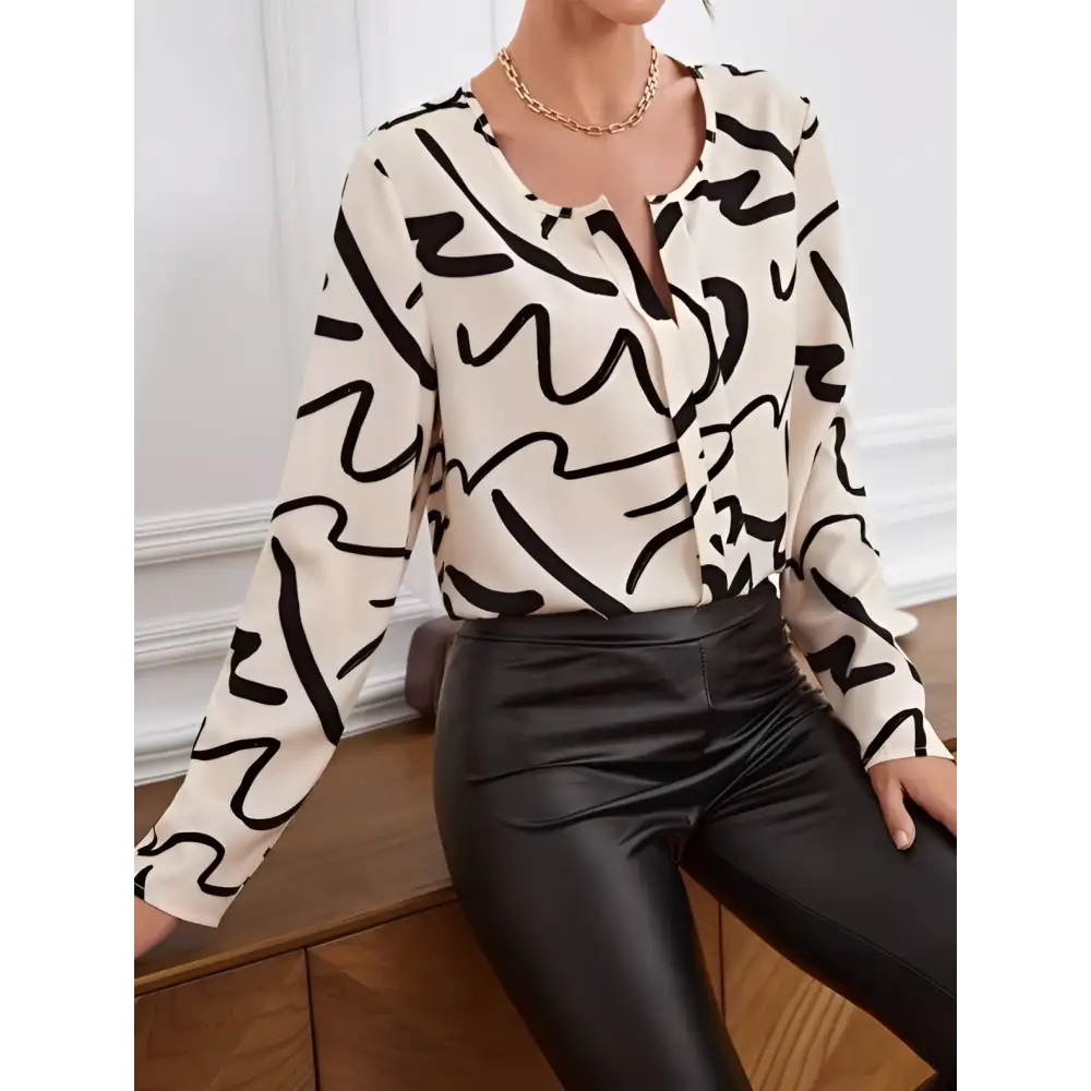 Cream-colored ladies printed fashionable loose shirt with bold black abstract line pattern and long sleeves