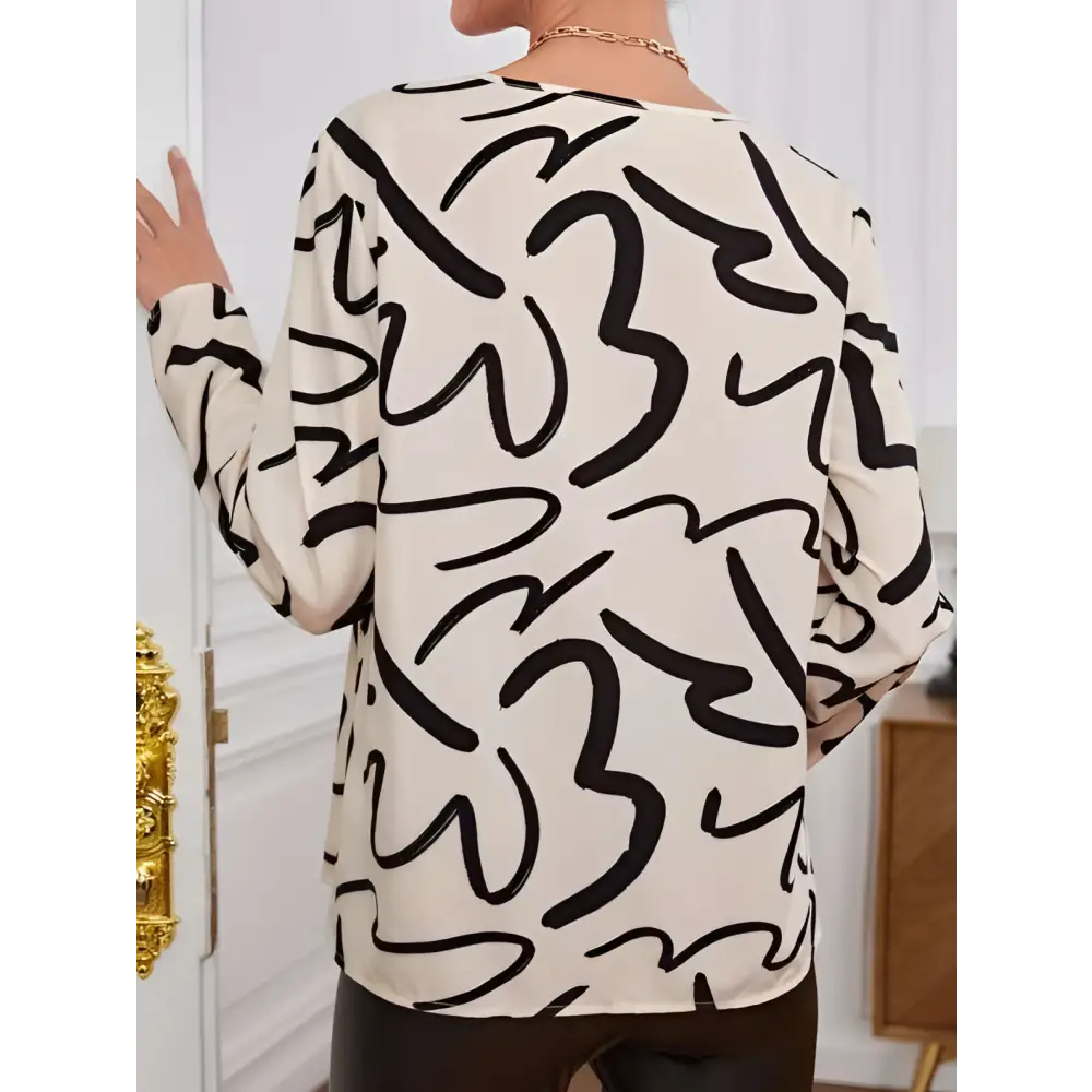 Cream-colored ladies printed fashionable loose shirt with bold black abstract line pattern and long sleeves